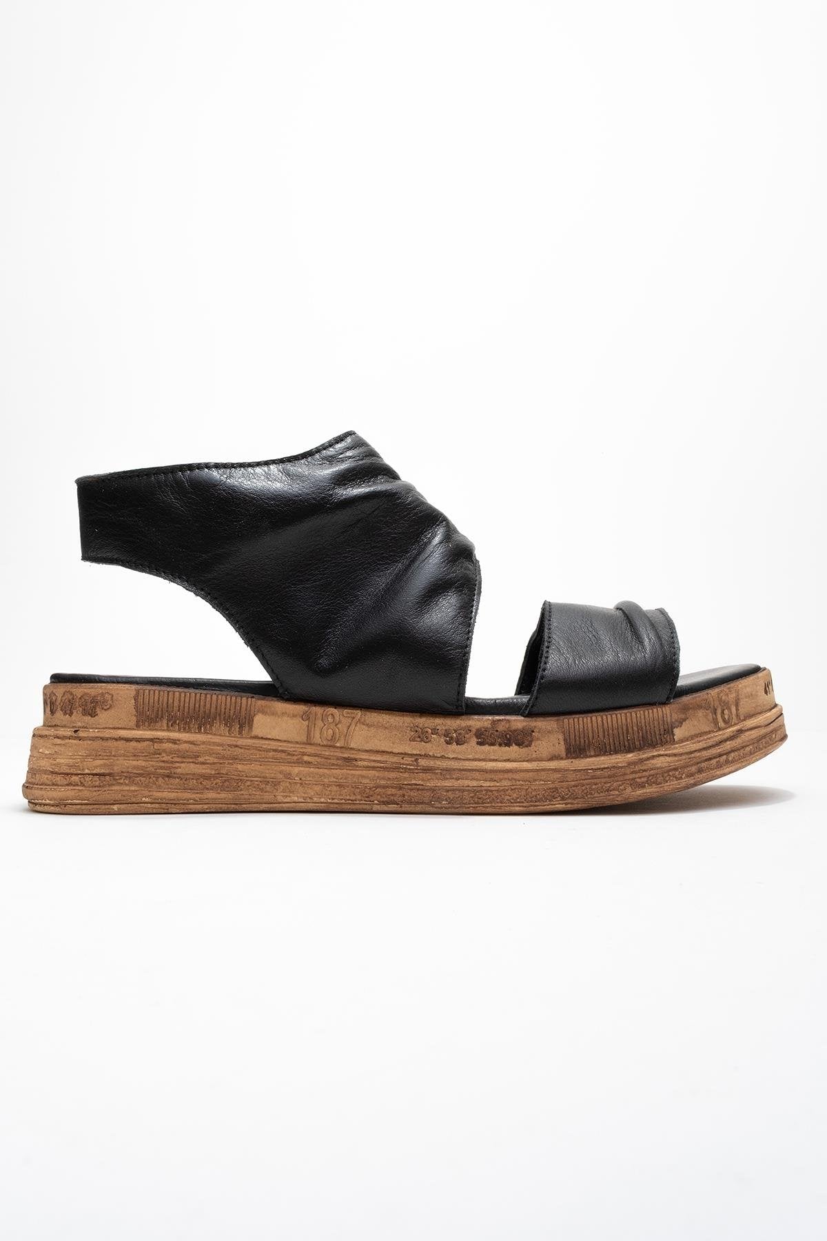 Lunas Black Leather Side‑Zip Flat Heel Sandal (Women)